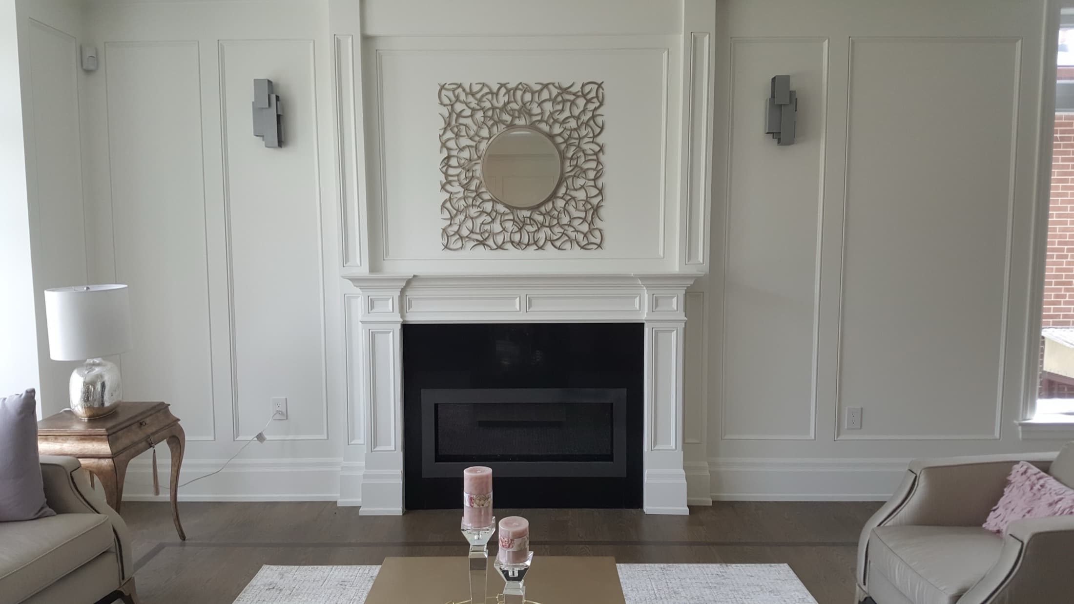 Painted fireplace mantel with a panelled overmantel and flanking wall panels