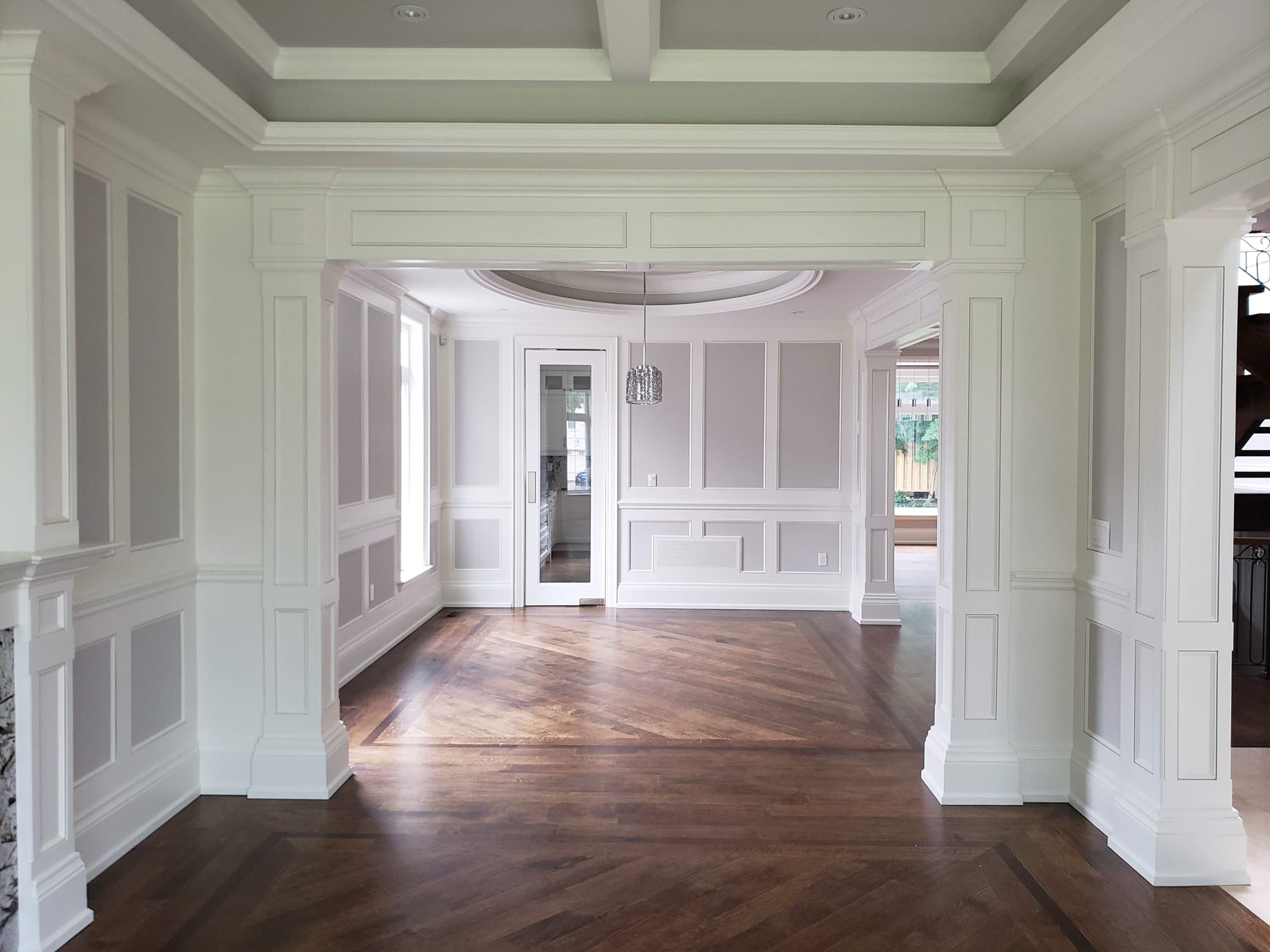 Panelled dining room with fluted columns and a cased opening