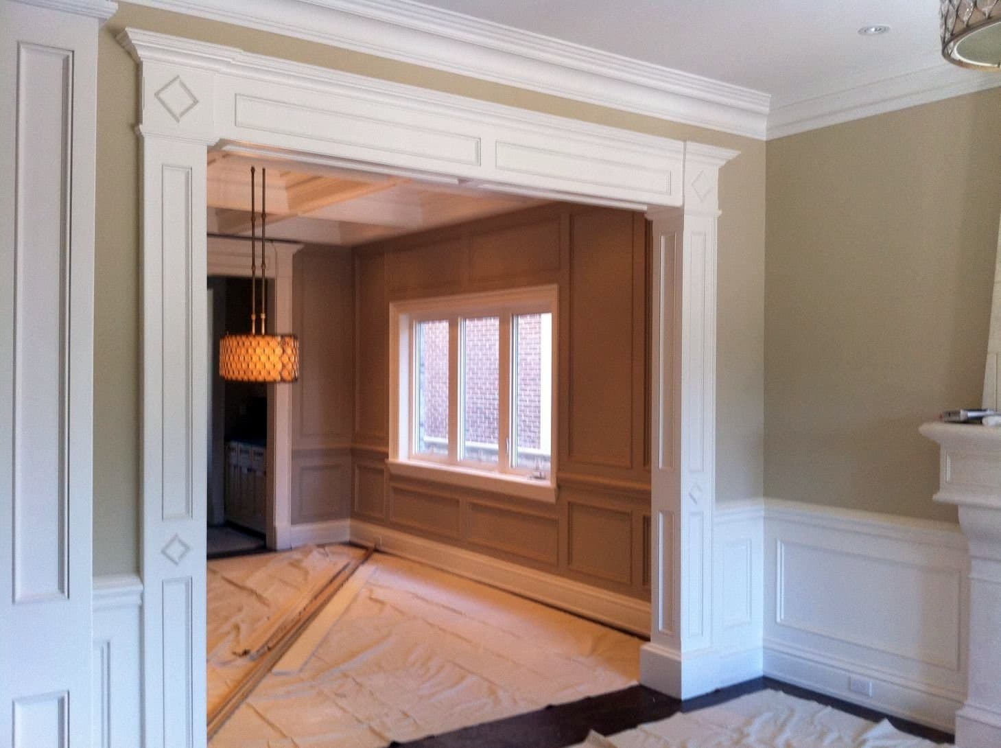 Cased opening with pilasters and panelled walls during installation